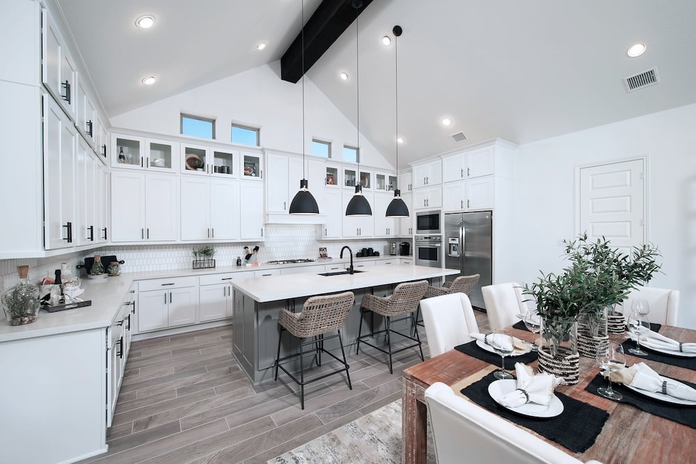 white open concept kitchen with black pendant lights