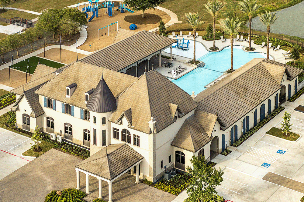 aerial view of community center with pool and palm trees