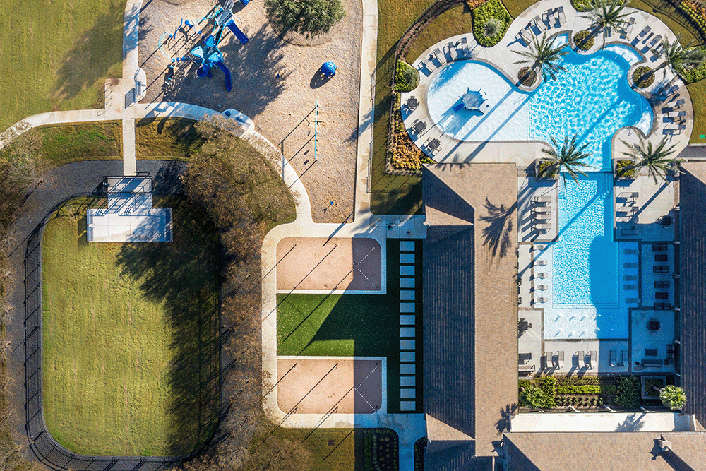 Aerial view of a large pool and community amenities